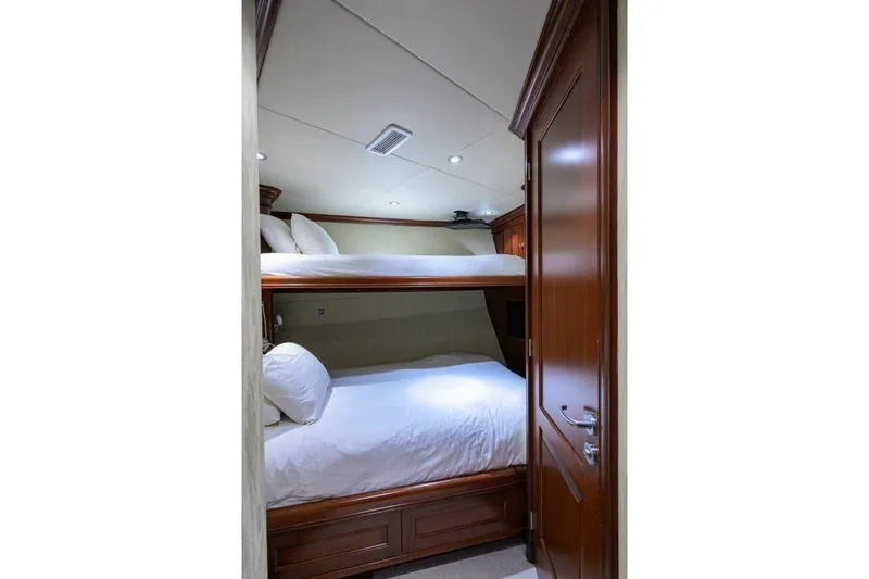 Compass Rose Yacht Photos Pics 2011 C & G Boatworks Explorer cabin with wooden bunk beds and white bedding.