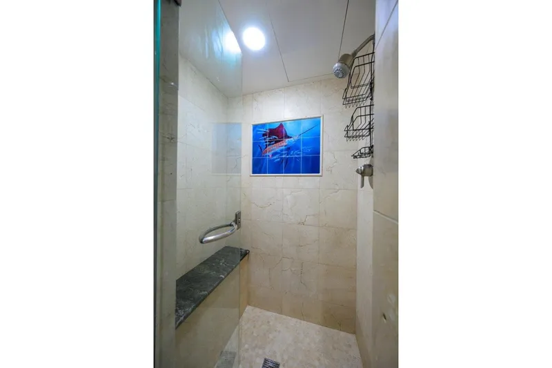 Compass Rose Yacht Photos Pics Luxurious shower in 2011 C & G Boatworks Explorer yacht, featuring elegant marble tiles.
