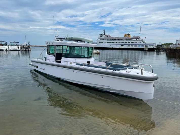 Girafft Yacht Photos Pics 2022 Axopar 28 Cabin Aft Cabin boat docked in a calm marina.
