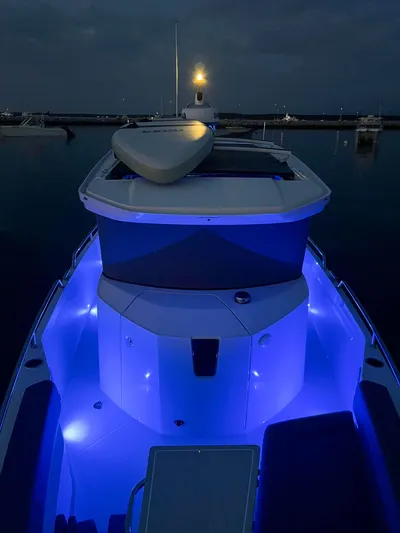 Girafft Yacht Photos Pics 2022 Axopar 28 Cabin Aft Cabin boat with blue LED lights at night.