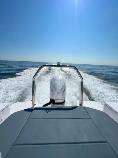 Girafft Yacht Photos Pics 2022 Axopar 28 Cabin Aft Cabin cruising on open water under clear blue sky.