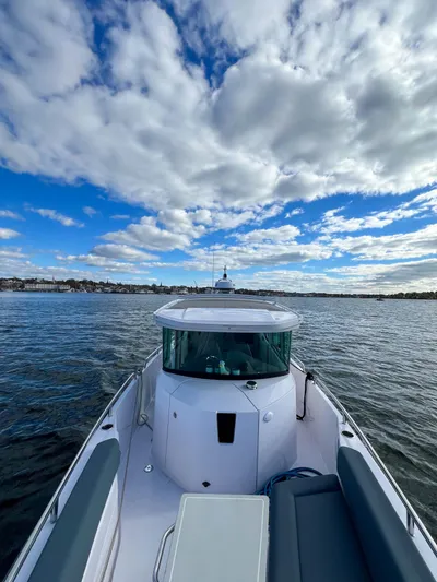 Girafft Yacht Photos Pics 2022 Axopar 28 Cabin Aft Cabin boat on open water under cloudy sky.