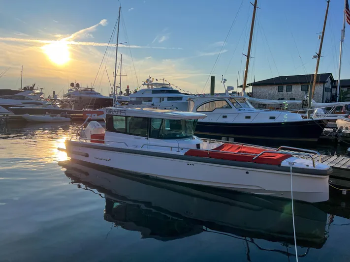 Girafft Yacht Photos Pics 2022 Axopar 28 Cabin Aft Cabin boat docked at sunset in a marina.
