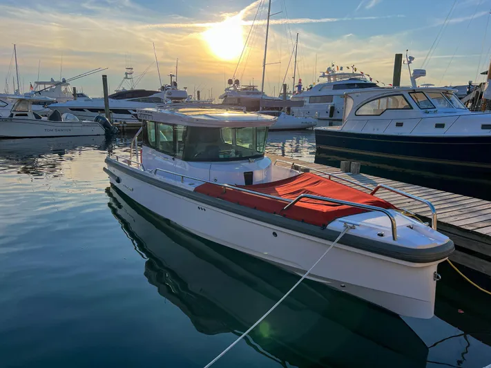 Girafft Yacht Photos Pics 2022 Axopar 28 Cabin Aft Cabin boat docked at sunset in a marina.