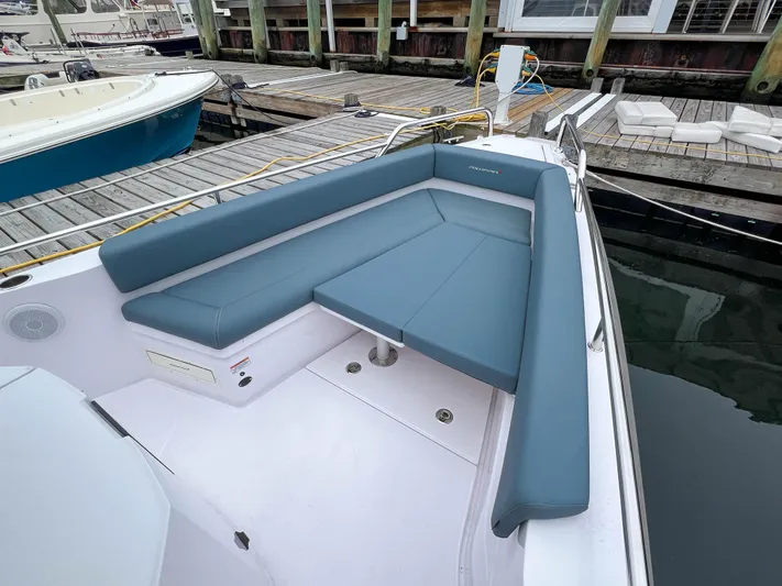 Girafft Yacht Photos Pics 2022 Axopar 28 Cabin Aft Cabin boat with blue seating at dock.