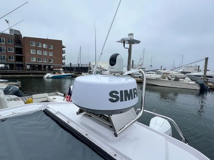 Girafft Yacht Photos Pics 2022 Axopar 28 Cabin Aft Cabin docked, featuring Simrad radar, marina background.