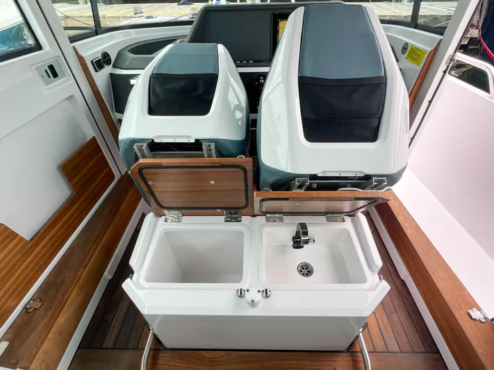 Girafft Yacht Photos Pics 2022 Axopar 28 Cabin Aft Cabin interior with dual seats and sink area.