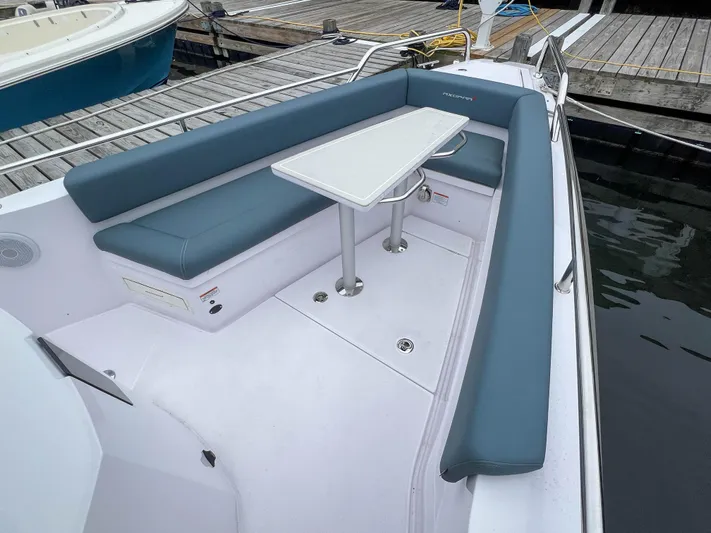 Girafft Yacht Photos Pics 2022 Axopar 28 Cabin Aft Cabin boat with blue seating and white table.
