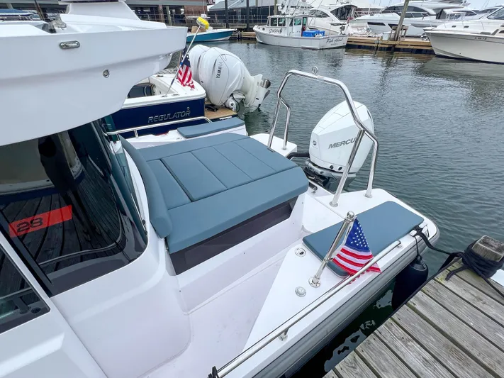 Girafft Yacht Photos Pics 2022 Axopar 28 Cabin Aft Cabin boat docked, featuring Mercury engine and American flag.