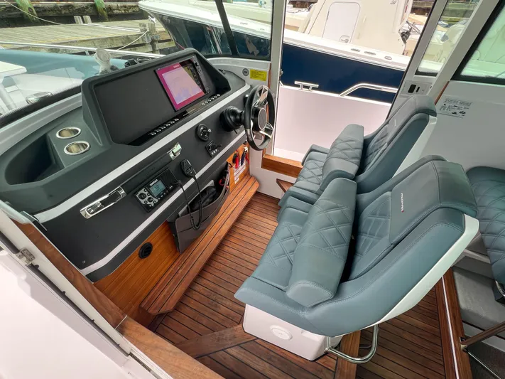 Girafft Yacht Photos Pics 2022 Axopar 28 Cabin Aft Cabin interior with modern helm and comfortable seating.