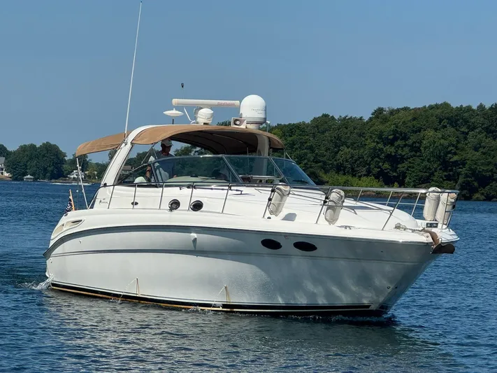  Yacht Photos Pics 2001 Sea Ray 380 Sundancer yacht cruising on a serene lake with lush green shoreline.