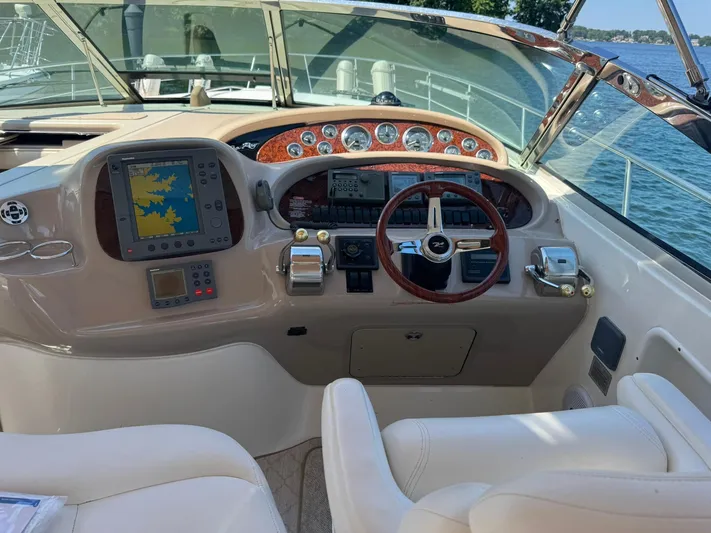 Yacht Photos Pics Helm of 2001 Sea Ray 380 Sundancer with navigation equipment and steering wheel.
