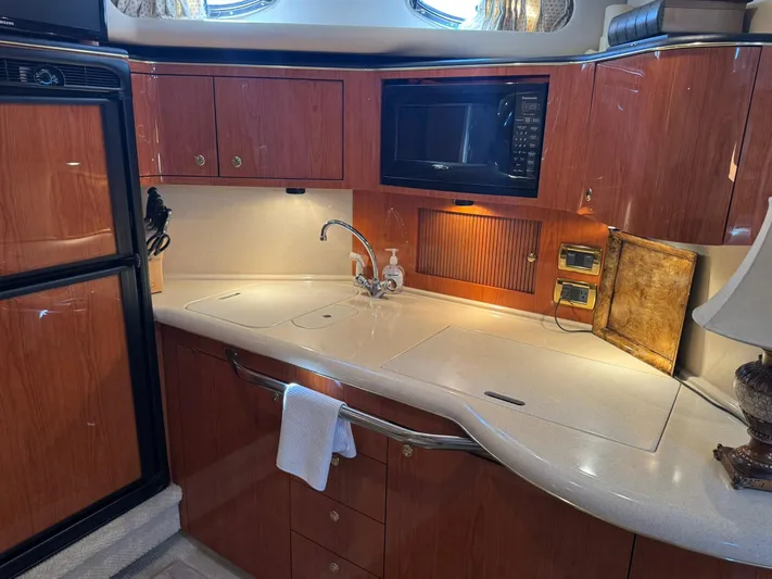  Yacht Photos Pics Luxurious kitchen area in a 2001 Sea Ray 380 Sundancer yacht with wood cabinetry.