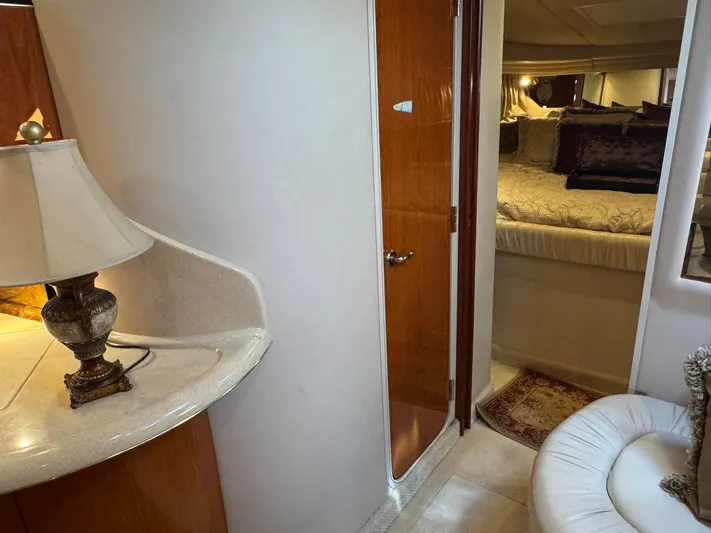  Yacht Photos Pics Interior of 2001 Sea Ray 380 Sundancer yacht with cozy bedroom and elegant lamp.