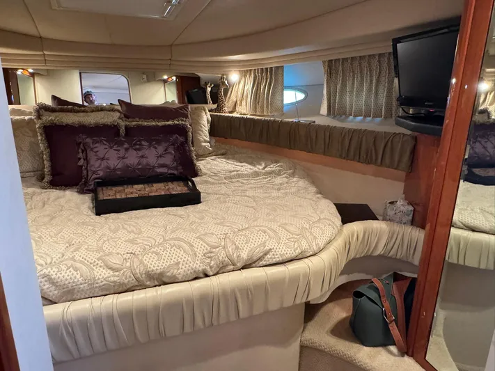  Yacht Photos Pics Luxurious cabin interior of 2001 Sea Ray 380 Sundancer yacht with cozy bedding and TV.