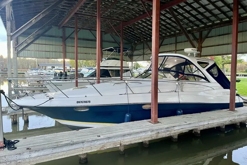  Yacht Photos Pics 2008 Regal Commodore 3760 IO docked under a covered marina.