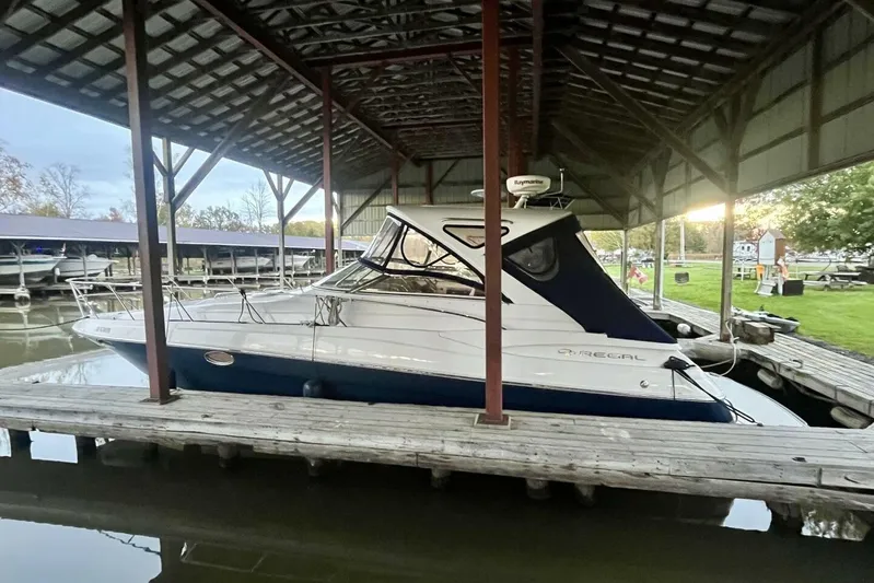  Yacht Photos Pics 2008 Regal Commodore 3760 IO boat docked under a covered marina.