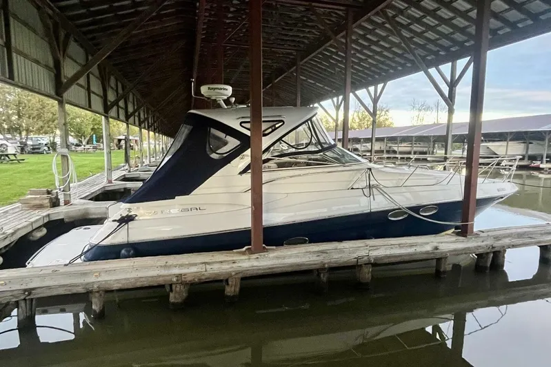  Yacht Photos Pics 2008 Regal Commodore 3760 IO boat docked under covered marina.