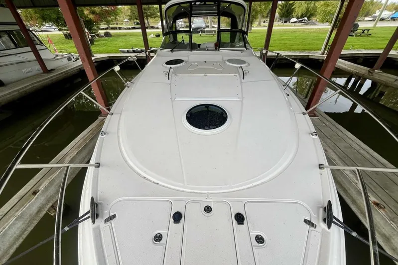  Yacht Photos Pics 2008 Regal Commodore 3760 IO boat docked under a covered marina.