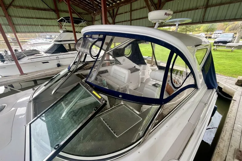  Yacht Photos Pics 2008 Regal Commodore 3760 IO boat docked under a covered marina.