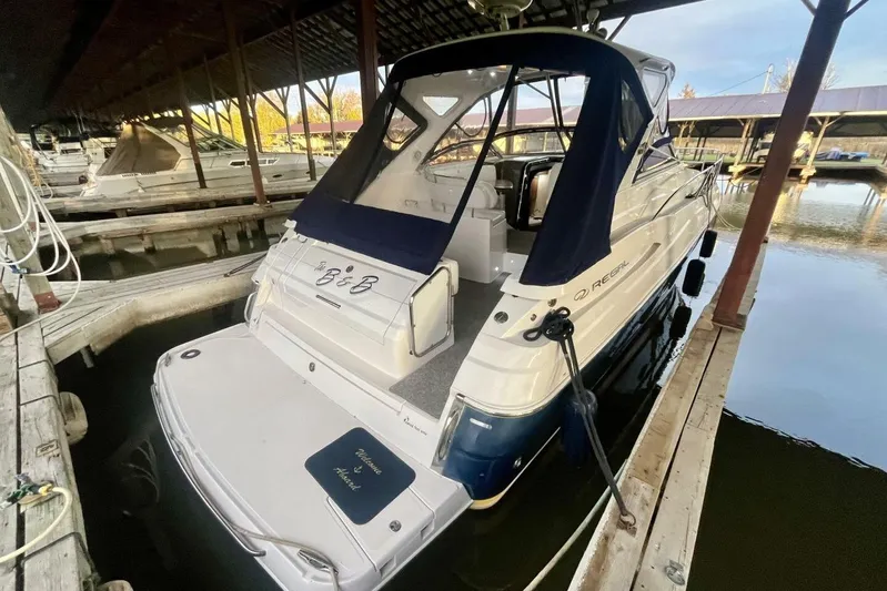  Yacht Photos Pics 2008 Regal Commodore 3760 IO docked in a marina, featuring a sleek design and covered seating.