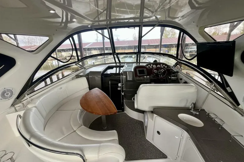  Yacht Photos Pics 2008 Regal Commodore 3760 IO boat interior with helm, seating, and table.