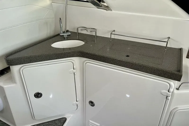  Yacht Photos Pics 2008 Regal Commodore 3760 IO boat kitchenette with sink and storage cabinets.