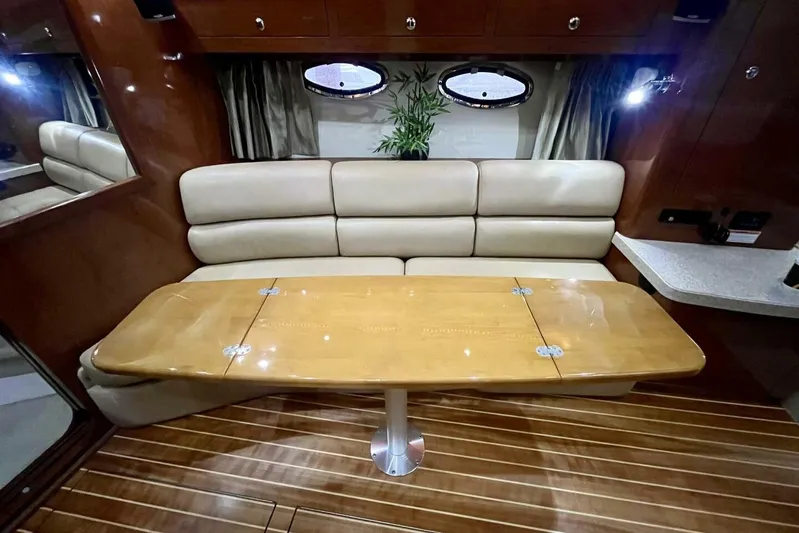  Yacht Photos Pics Interior of 2008 Regal Commodore 3760 IO with wooden table and beige seating.