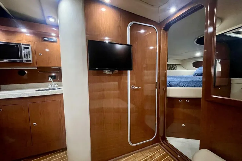  Yacht Photos Pics Interior of 2008 Regal Commodore 3760 IO yacht with kitchenette and cozy sleeping area.