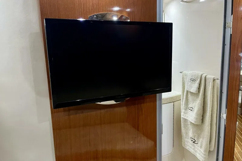  Yacht Photos Pics Flat-screen TV in 2008 Regal Commodore 3760 IO yacht interior, near bathroom with towels.