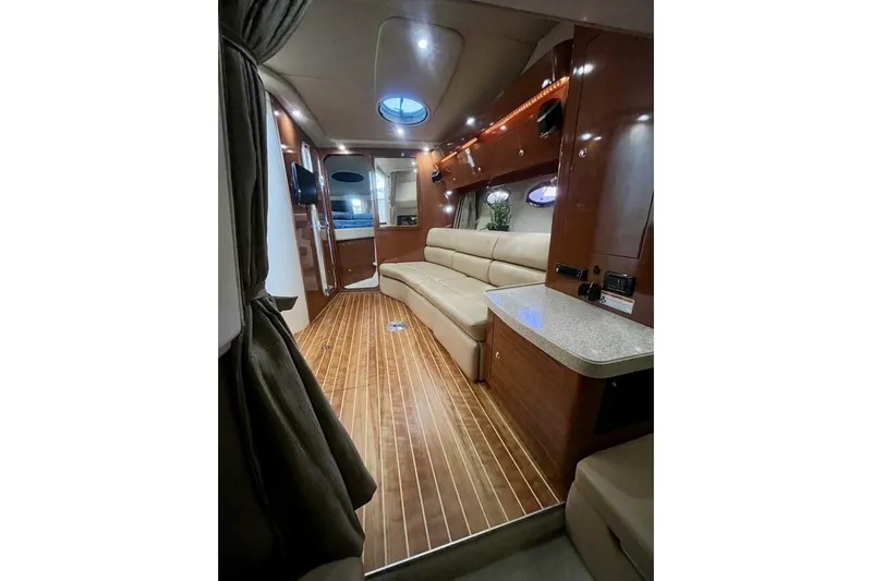  Yacht Photos Pics Luxurious interior of 2008 Regal Commodore 3760 IO yacht with wood flooring and plush seating.