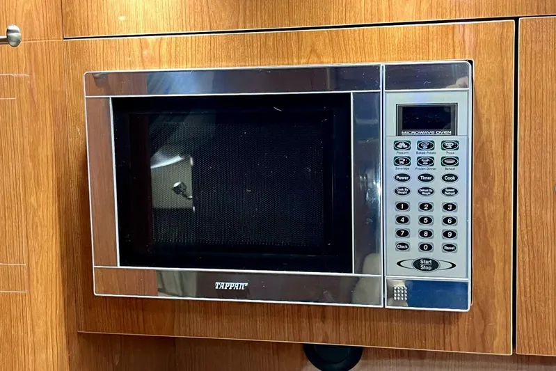  Yacht Photos Pics Built-in microwave oven on Regal Commodore 3760 IO, 2008 model, with wood paneling.