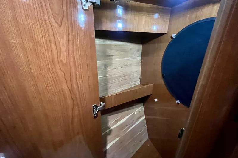  Yacht Photos Pics Interior of 2008 Regal Commodore 3760 IO boat, featuring wooden cabinetry and storage space.