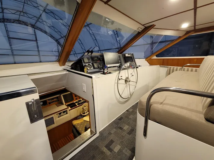 Golden Eagle Yacht Photos Pics Interior of 1989 Broward Raised Pilothouse MY, featuring helm station and seating area.