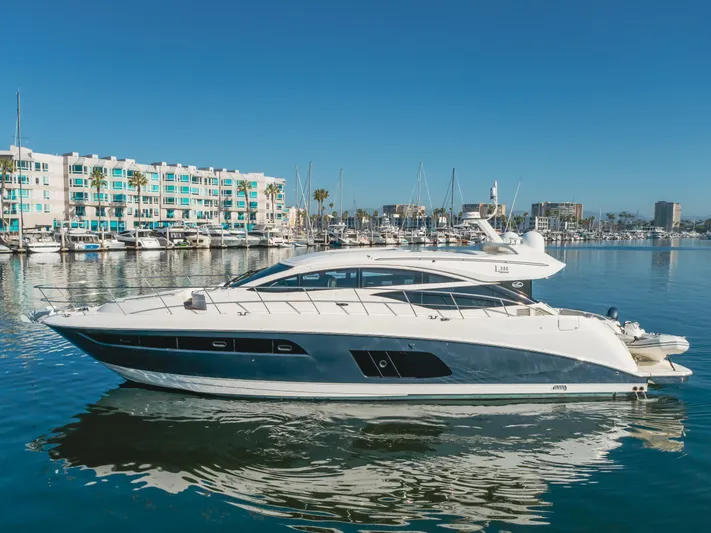 No Regrets Yacht Photos Pics 2016 Sea Ray L590 yacht docked in a marina with waterfront buildings in the background.