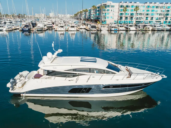 No Regrets Yacht Photos Pics 2016 Sea Ray L590 yacht docked in a marina with surrounding boats and buildings.