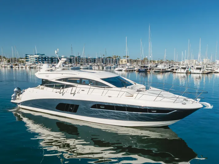 No Regrets Yacht Photos Pics 2016 Sea Ray L590 yacht docked in a marina under clear blue skies.