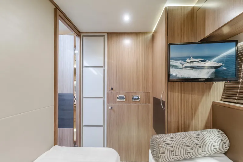 No Regrets Yacht Photos Pics Luxurious interior of 2016 Sea Ray L590 yacht with modern wood paneling and TV.