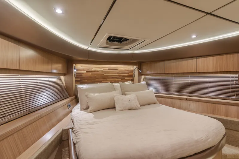 No Regrets Yacht Photos Pics Luxurious interior of 2016 Sea Ray L590 yacht with elegant wood finishes and cozy bedding.