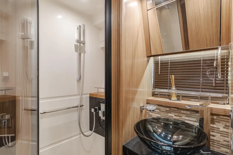 No Regrets Yacht Photos Pics Luxurious bathroom in 2016 Sea Ray L590 yacht with modern fixtures and glass sink.