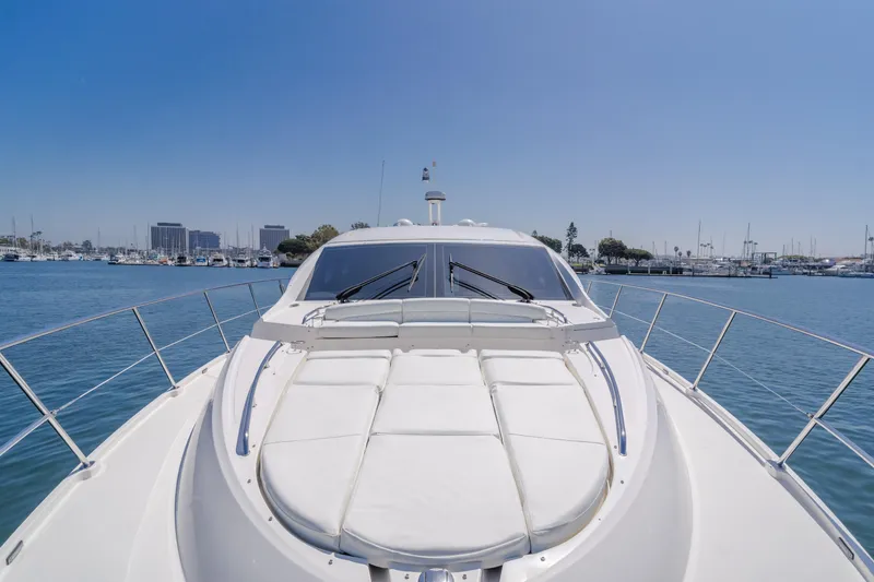 No Regrets Yacht Photos Pics 2016 Sea Ray L590 yacht on calm water, clear sky, marina in background.