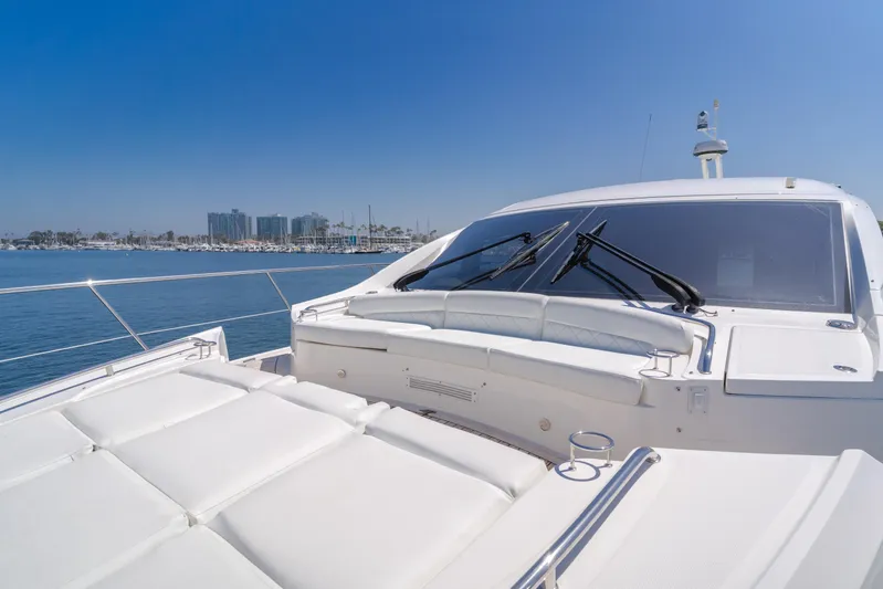 No Regrets Yacht Photos Pics 2016 Sea Ray L590 yacht on calm water with city skyline in background.
