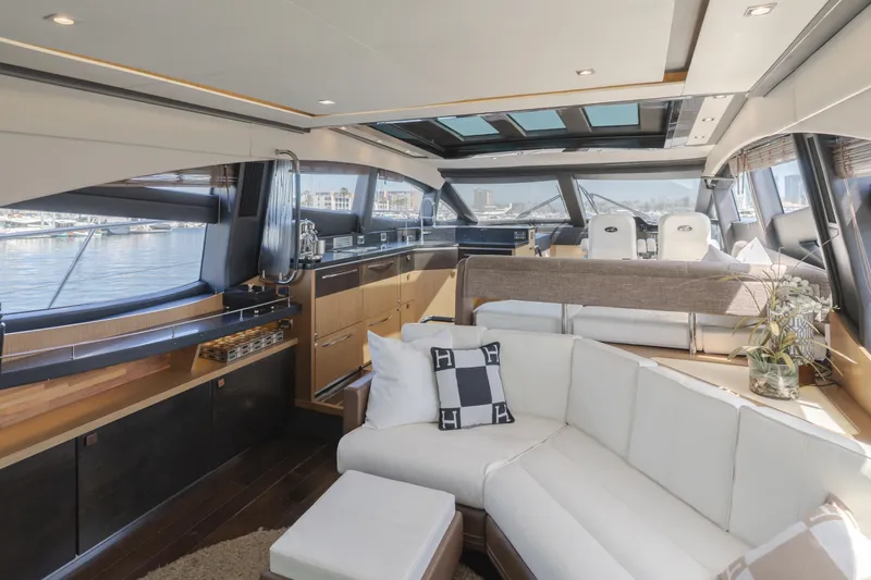No Regrets Yacht Photos Pics Luxurious interior of 2016 Sea Ray L590 yacht with modern furnishings and panoramic windows.