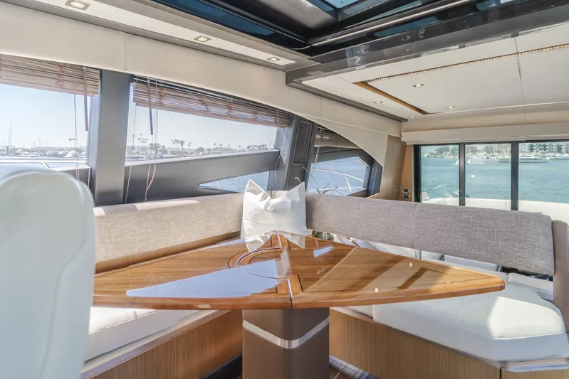 No Regrets Yacht Photos Pics Luxurious interior of 2016 Sea Ray L590 yacht with elegant dining area and panoramic windows.