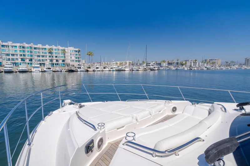 No Regrets Yacht Photos Pics 2016 Sea Ray L590 yacht deck overlooking marina with modern buildings and clear blue sky.