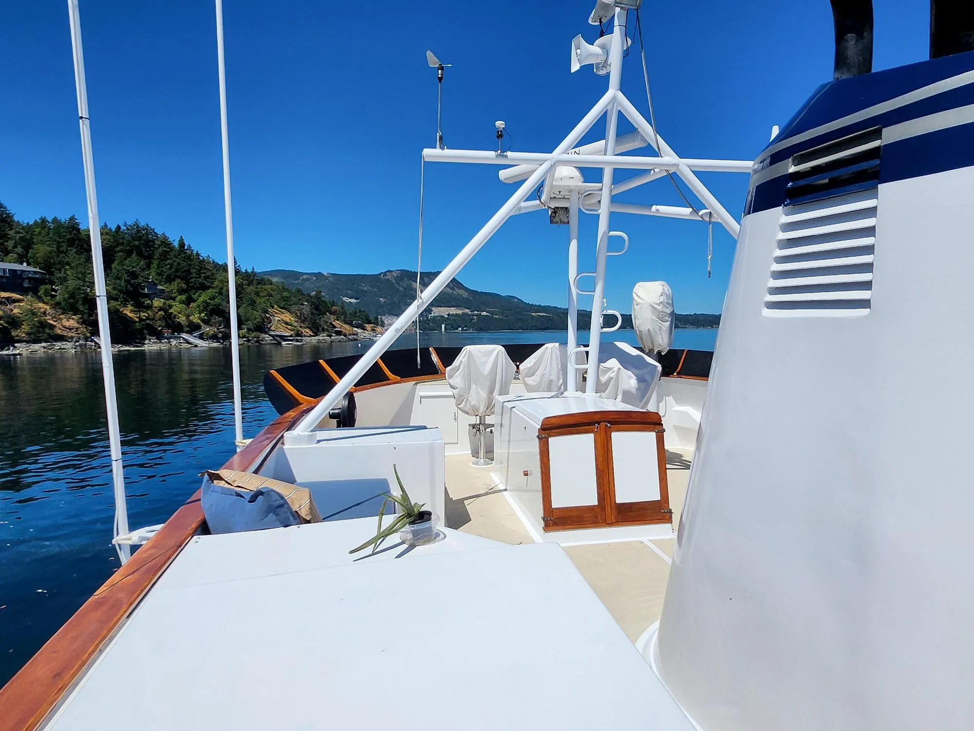 Custom 1967 74 George Moore Passagemaker yacht on calm water, clear sky, scenic background.