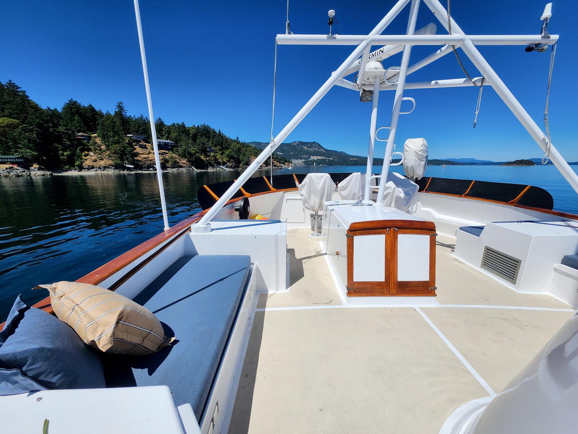 1967 Custom 74 George Moore Passagemaker yacht deck with scenic coastal view.