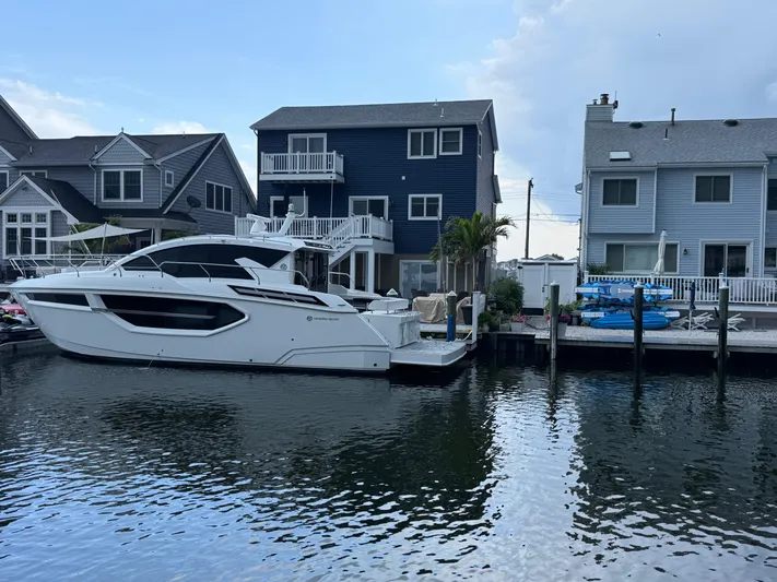  Yacht Photos Pics 2018 Cruisers Yachts 42 Cantius docked near waterfront homes.