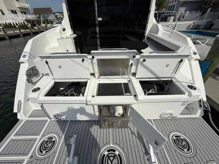  Yacht Photos Pics 2018 Cruisers Yachts 42 Cantius deck with open storage compartments and grill.