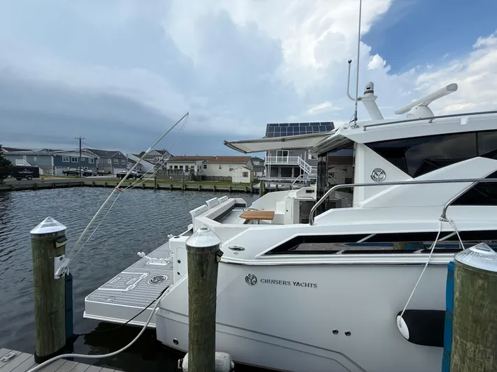  Yacht Photos Pics 2018 Cruisers Yachts 42 Cantius docked at marina, overcast sky.